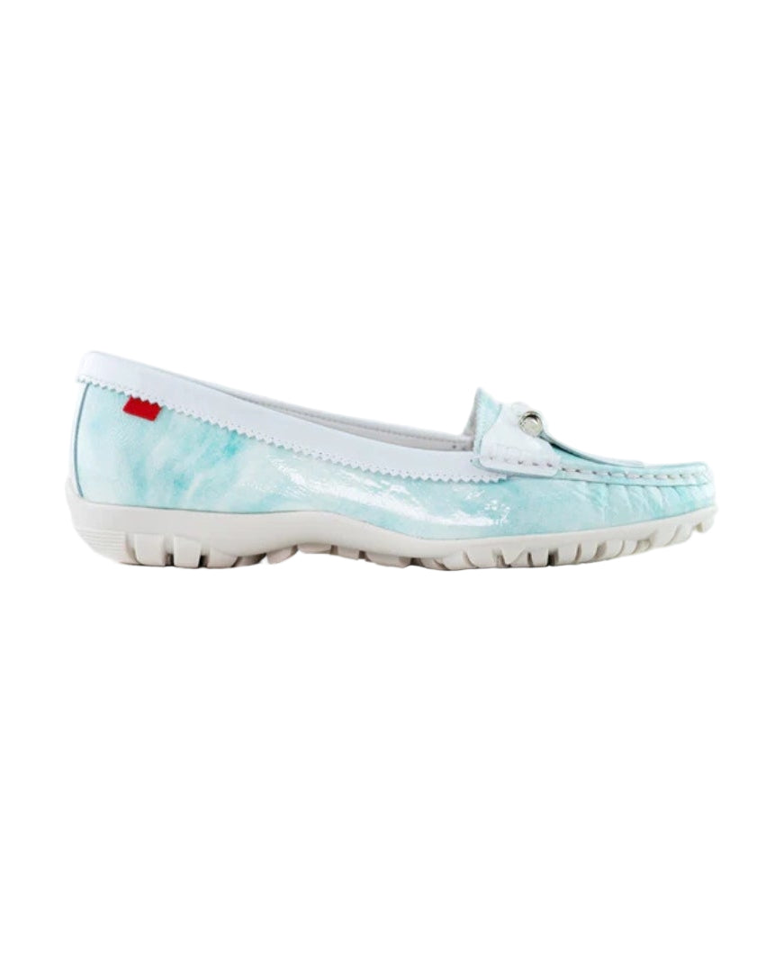 Light blue slip-on shoe with a red label on a white background